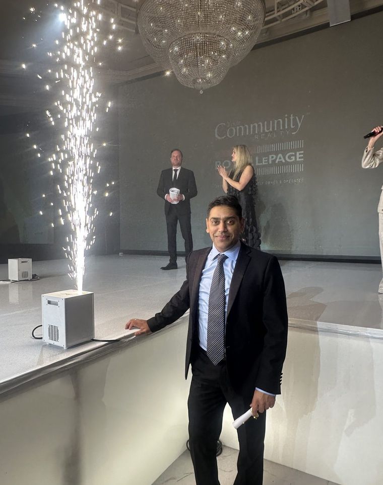 Robin Patel at an awards evening as a stage fountain fires behind him.